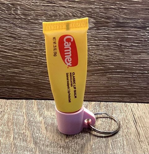 Lip balm tube with a keyring cap