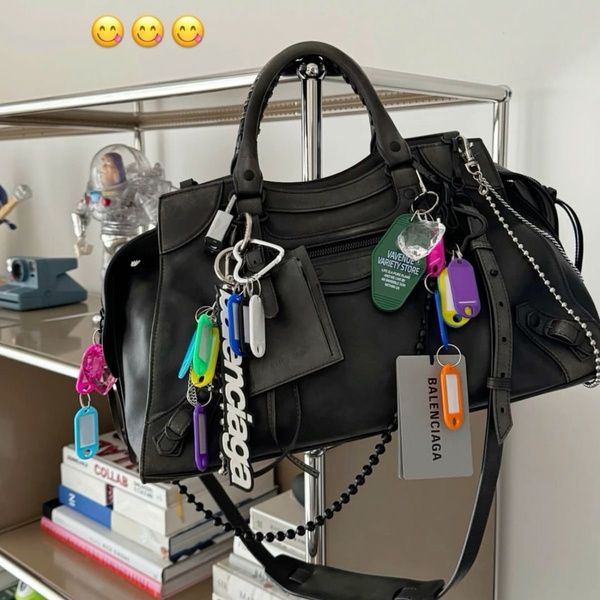 Black bag with keyrings and charms